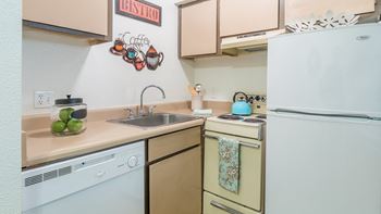 El Encanto kitchen with dishwasher and refrigerator. 